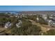 Aerial view of a two story home situated on a golf course near the water at 279 Driftwood Ln, Edisto Beach, SC 29438