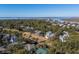 Aerial view of community featuring numerous homes near a golf course and waterfront at 279 Driftwood Ln, Edisto Beach, SC 29438