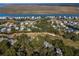 Aerial view of a coastal neighborhood with houses and a golf course at 279 Driftwood Ln, Edisto Beach, SC 29438
