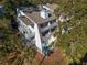 Two-story home with balconies, decks, and exterior stairs; surrounded by lush greenery at 279 Driftwood Ln, Edisto Beach, SC 29438