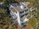 Two-story home with multiple balconies, decks, and exterior stairs; nestled in trees at 279 Driftwood Ln, Edisto Beach, SC 29438