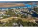 Aerial view showing neighborhood homes near golf course and water at 279 Driftwood Ln, Edisto Beach, SC 29438