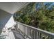 Private balcony overlooking lush trees and landscape at 279 Driftwood Ln, Edisto Beach, SC 29438