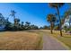 Paved path meanders through lush landscaping and leads to homes at 279 Driftwood Ln, Edisto Beach, SC 29438