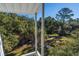View from balcony overlooking lush trees and green space at 279 Driftwood Ln, Edisto Beach, SC 29438