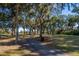 Walking path through a canopy of trees with Spanish moss at 279 Driftwood Ln, Edisto Beach, SC 29438