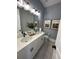 Double vanity bathroom with white cabinets and grey tile floors at 304 Trailmore Ln, Summerville, SC 29486