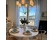 Bright dining room with round table, chandelier, and hardwood floors at 304 Trailmore Ln, Summerville, SC 29486