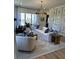 Spacious living room with light-colored sofa, wood accents, and large windows at 304 Trailmore Ln, Summerville, SC 29486