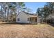 Large backyard with a screened porch and mature trees at 407 Kingbird Road, Ladson, SC 29456