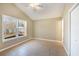 Bright bedroom with tile flooring, neutral walls, and a window offering backyard views at 407 Kingbird Road, Ladson, SC 29456