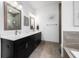 Double vanity bathroom with dark brown cabinets and gray tile floors at 454 Woodland Shores Rd, Charleston, SC 29412