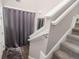 Modern carpeted staircase with gray walls and white railing at 454 Woodland Shores Rd, Charleston, SC 29412