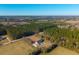 Aerial view of house with pool and large yard surrounded by trees and farmland at 534 Farmers Market Rd, Saint George, SC 29477
