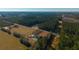 Aerial view of house with pool and large yard surrounded by trees and farmland at 534 Farmers Market Rd, Saint George, SC 29477