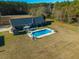 Aerial view showcasing a home's backyard oasis, complete with a sparkling pool at 534 Farmers Market Rd, Saint George, SC 29477
