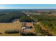 Aerial view of house with pool and large yard surrounded by trees and farmland at 534 Farmers Market Rd, Saint George, SC 29477