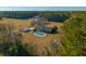 Aerial view of house with pool and large yard surrounded by trees and farmland at 534 Farmers Market Rd, Saint George, SC 29477