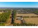 Aerial view of house with pool and large yard surrounded by trees and farmland at 534 Farmers Market Rd, Saint George, SC 29477