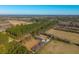 Aerial view of house with pool and large yard surrounded by trees and farmland at 534 Farmers Market Rd, Saint George, SC 29477