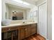 Bathroom with double vanity, large mirror, and wooden cabinets at 534 Farmers Market Rd, Saint George, SC 29477
