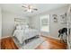 Bedroom with a white metal bed frame, hardwood floors, and a ceiling fan at 534 Farmers Market Rd, Saint George, SC 29477