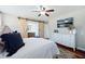 Main bedroom with hardwood floors, a ceiling fan, and barn door entry at 534 Farmers Market Rd, Saint George, SC 29477