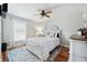 Bedroom with a white upholstered bed frame, hardwood floors, and a ceiling fan at 534 Farmers Market Rd, Saint George, SC 29477
