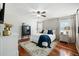Main bedroom with hardwood floors, a ceiling fan, and barn door entry at 534 Farmers Market Rd, Saint George, SC 29477