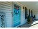 Blue front door with welcoming decor and porch at 534 Farmers Market Rd, Saint George, SC 29477