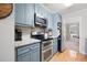 Updated kitchen featuring granite countertops and blue cabinets at 534 Farmers Market Rd, Saint George, SC 29477