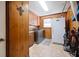 Functional laundry room with washer, dryer, and ample storage in wood cabinets at 534 Farmers Market Rd, Saint George, SC 29477
