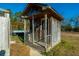 Rustic wooden shed with porch, located in the backyard at 534 Farmers Market Rd, Saint George, SC 29477
