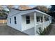 Renovated white house with a side porch and mature trees at 5614 Read St, North Charleston, SC 29406