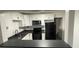 Updated kitchen with white cabinets and dark countertops at 5614 Read St, North Charleston, SC 29406