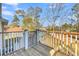 Wooden deck with white railing and wooded backyard views at 8048 New England Dr, North Charleston, SC 29420