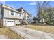 Two-story house with a driveway, gray siding, and a spacious yard at 8048 New England Dr, North Charleston, SC 29420