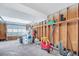 Unfinished garage with storage shelves and overhead door at 8048 New England Dr, North Charleston, SC 29420