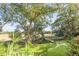 Landscaped backyard with a view of a marsh and a wooden dock at 853 Whispering Marsh Dr, Charleston, SC 29412