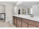 Double vanity bathroom with dark brown cabinets and a shower at 9736 Black Willow Ln, Ladson, SC 29456