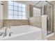 Bathroom with a large garden tub and a separate glass shower at 9736 Black Willow Ln, Ladson, SC 29456
