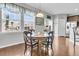Bright breakfast nook with round table and four chairs, hardwood floors at 9736 Black Willow Ln, Ladson, SC 29456