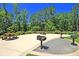 Outdoor grilling area with picnic tables, nestled in a wooded setting at 9736 Black Willow Ln, Ladson, SC 29456