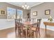 Formal dining room with hardwood floors, chandelier, and wainscoting at 9736 Black Willow Ln, Ladson, SC 29456