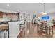 Open kitchen with island, granite countertops, and hardwood floors at 9736 Black Willow Ln, Ladson, SC 29456