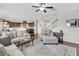 Open living room with hardwood floors, comfortable seating, and kitchen view at 9736 Black Willow Ln, Ladson, SC 29456
