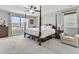Spacious main bedroom with large bed, window seating, and hardwood floors at 9736 Black Willow Ln, Ladson, SC 29456