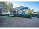 Green house exterior with screened porch and landscaped yard at 101 Ribbon Rd, Summerville, SC 29483
