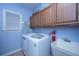 Convenient laundry room with washer, dryer, and utility sink at 101 Ribbon Rd, Summerville, SC 29483