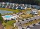 Aerial view showcasing community pool, playground, pickleball courts, and homes at 1011 Swamp Harrier Ave, Ravenel, SC 29470